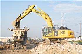 Transportation & Structures: A Komatsu PC360-11 loads a crusher with material along I-95 in Philadelphia, PA. 