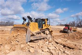 Site & Land Development: A CAT D8T and Case-IH equipped with a Ktec pan work a cut in Lehigh County, PA.